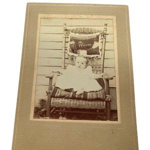 Antique Photograph Baby Girl Toddler Sitting in Wicker Chair Cardboard Frame